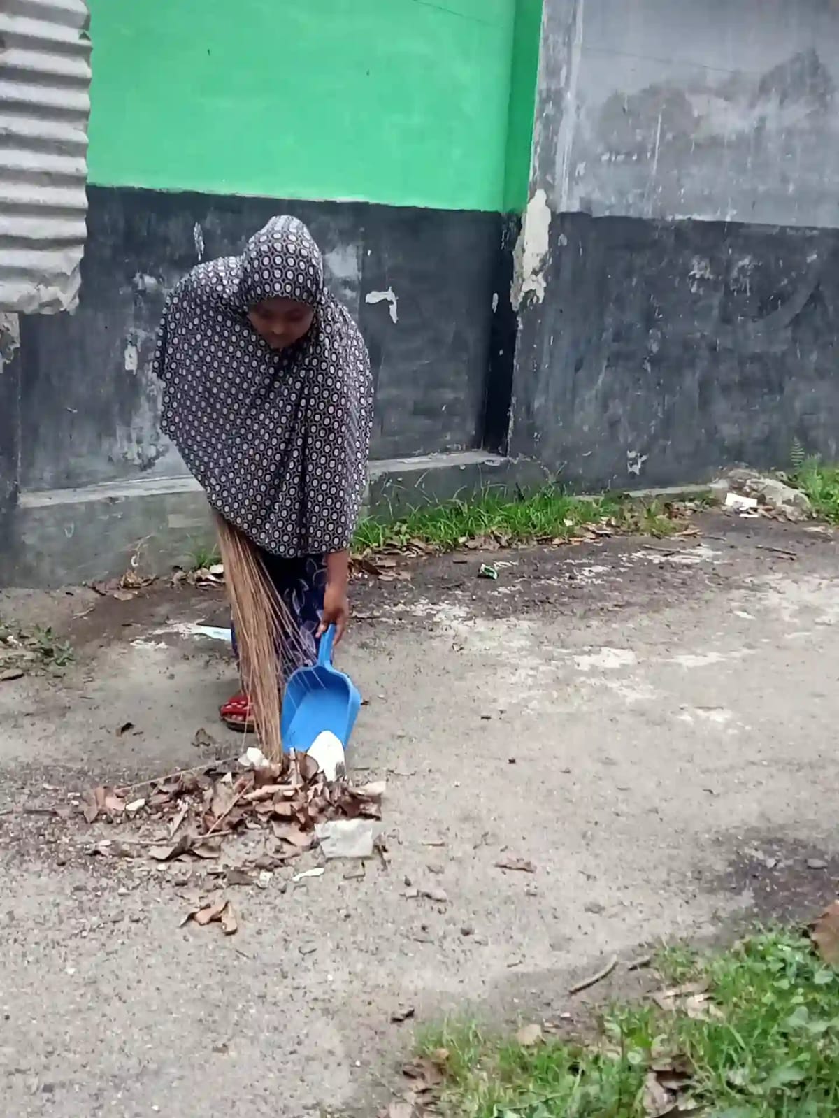 Ema cleaning her neighborhood