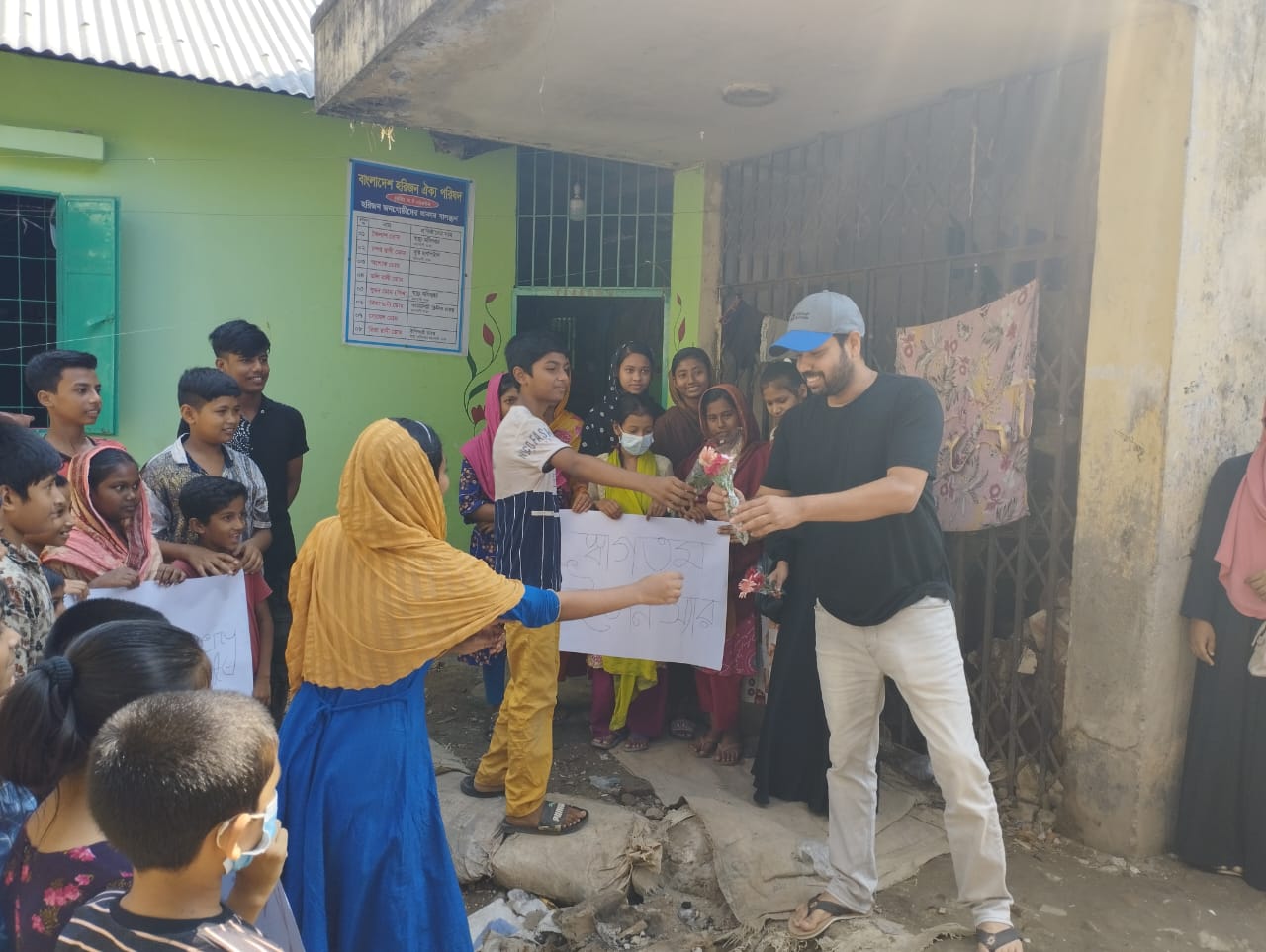 Kids in Mohakhali giving Mr. Evan Islam bouquets