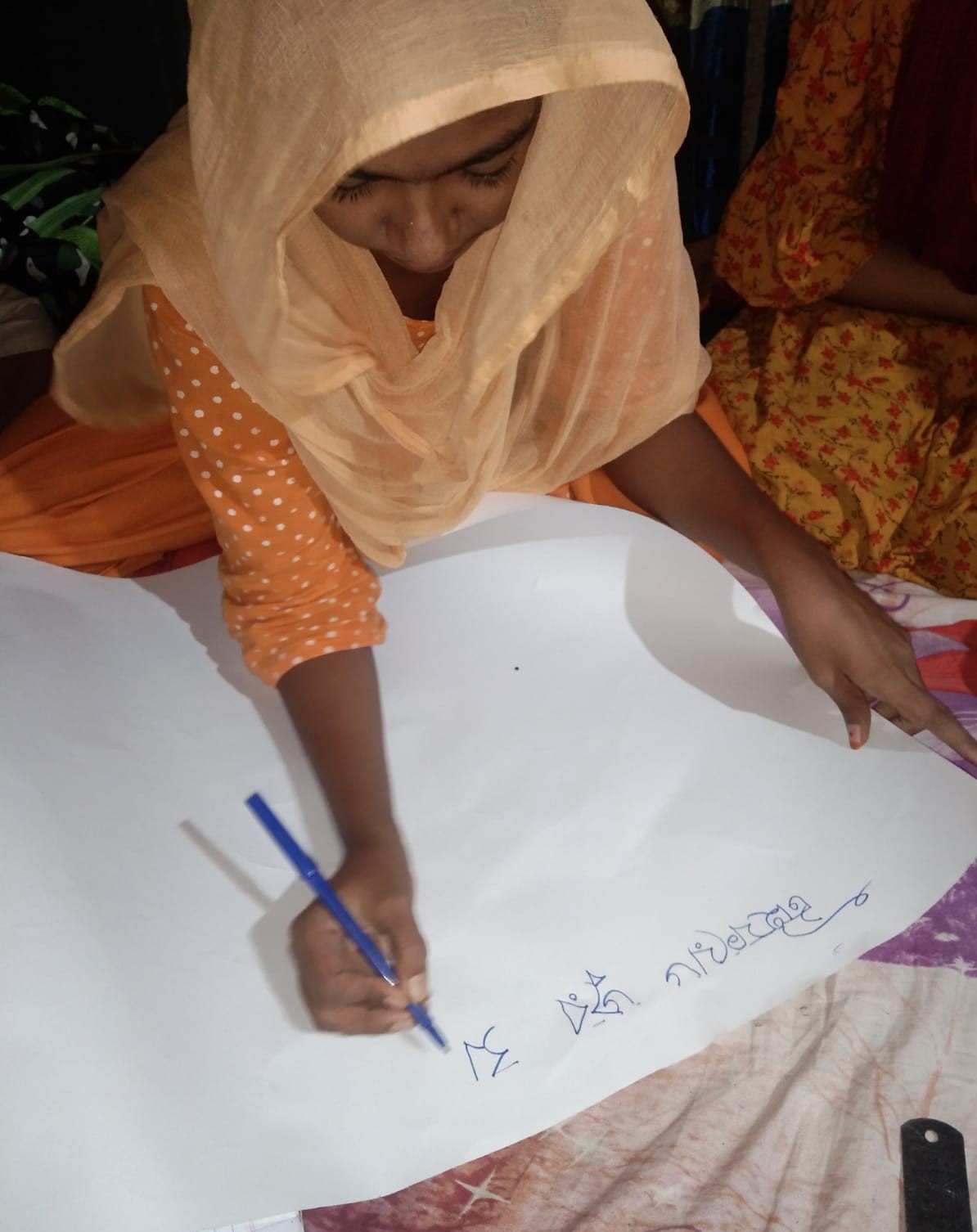 Farzana making a poster on typhoid awareness