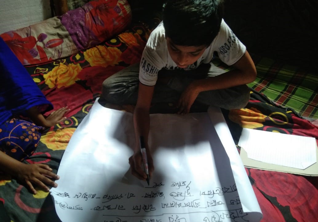 Jahid making a poster on typhoid awareness