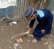 Abdullah cleaning the neighborhood