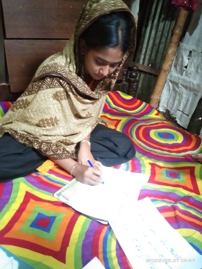 Farzana making a poster on child marriage awareness