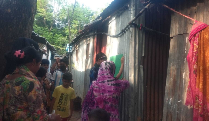 kids in mirpur hanging poster after cleaning