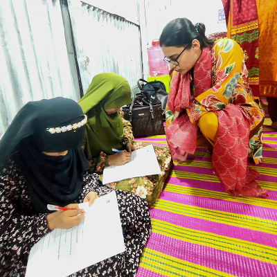 Kids filling out survey forms of menstrual health awareness program by Shapla Foundation 
