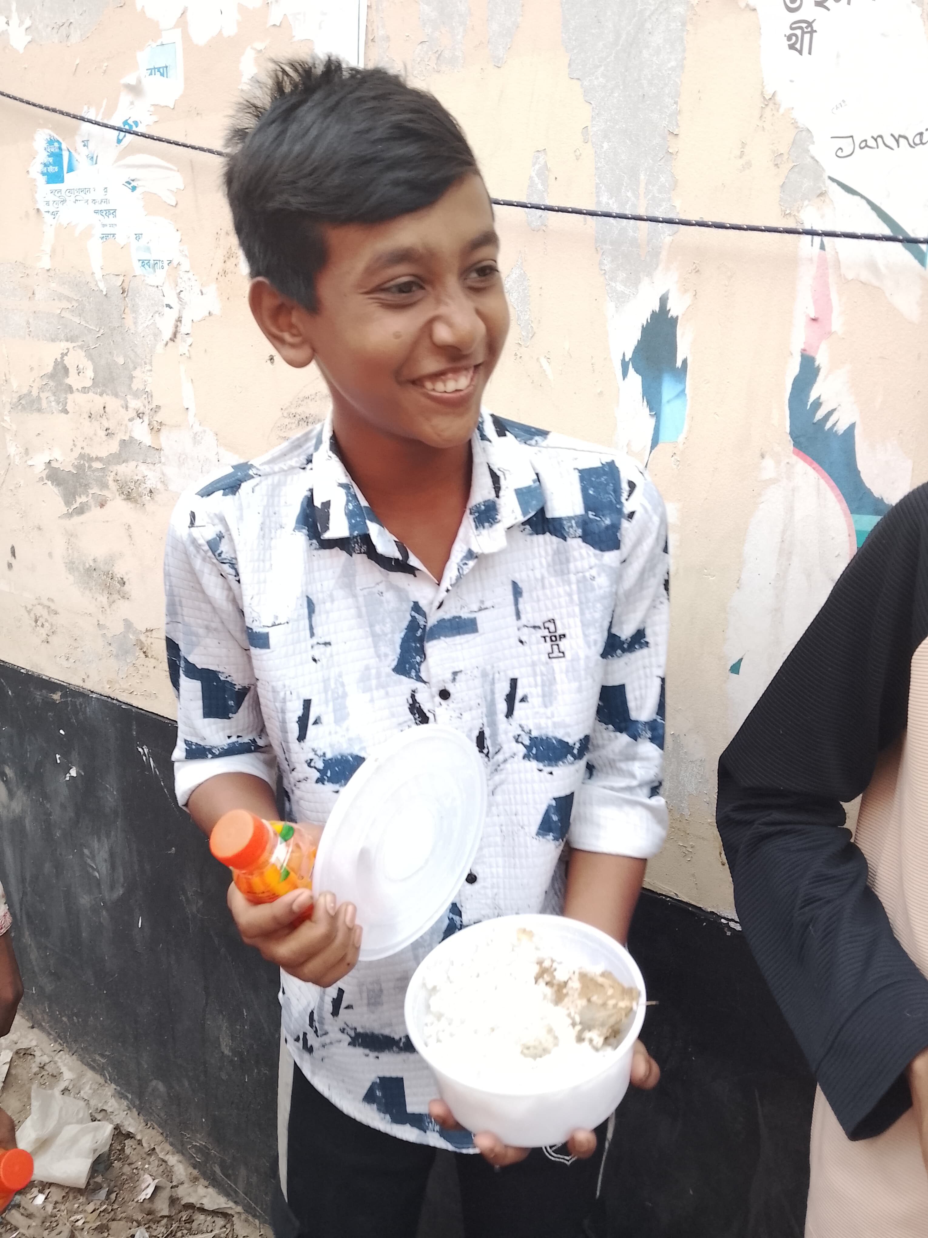Happy kid receiving iftar at Mohakhali
