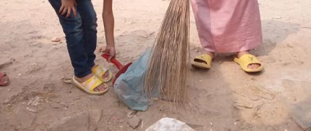 Salman and Isa cleaning the neighborhood