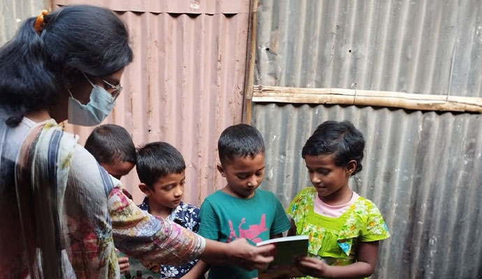 Dedicated caretaker distributing educational materials to young children
