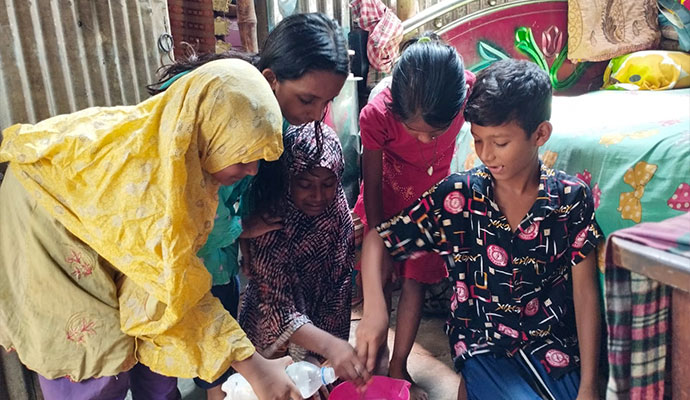 Children working together to prepare a homemade disinfectant solution in a bowl