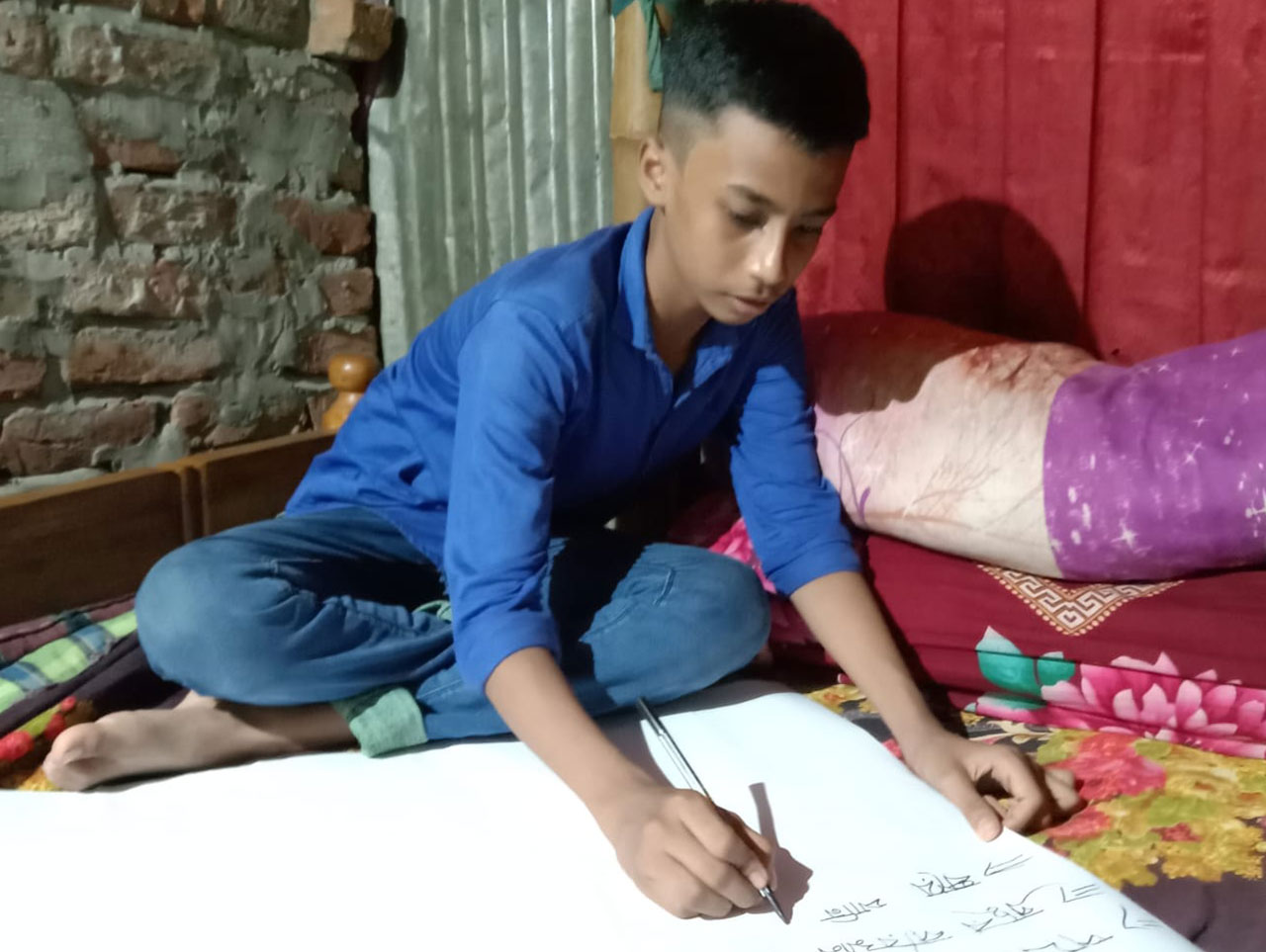 Kabir making a poster on dengue awareness