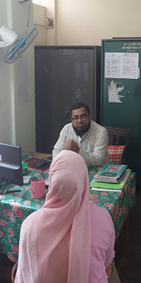 Shapla foundation representative is talking to Abdul Hamid at Mohakhali school