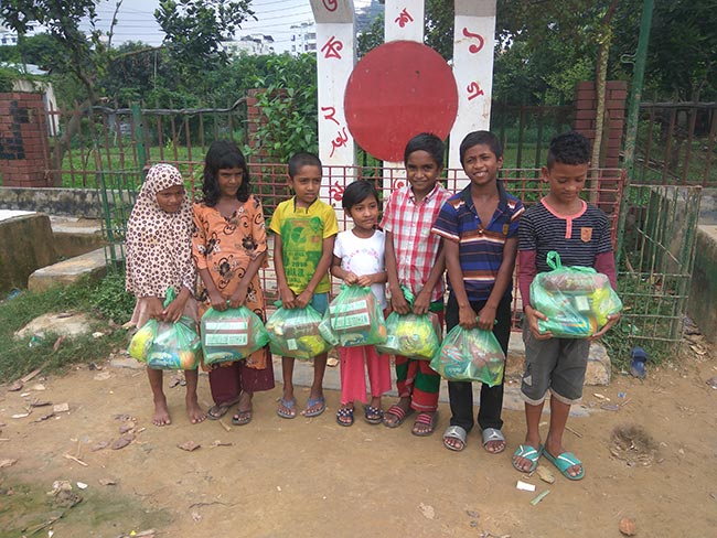 Children receiving goodies at Shapla event
