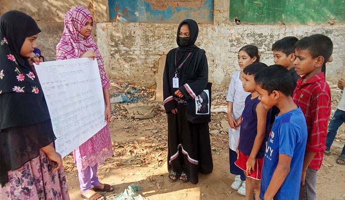 Coordinator and students presenting self-defense guidelines and safety awareness chart