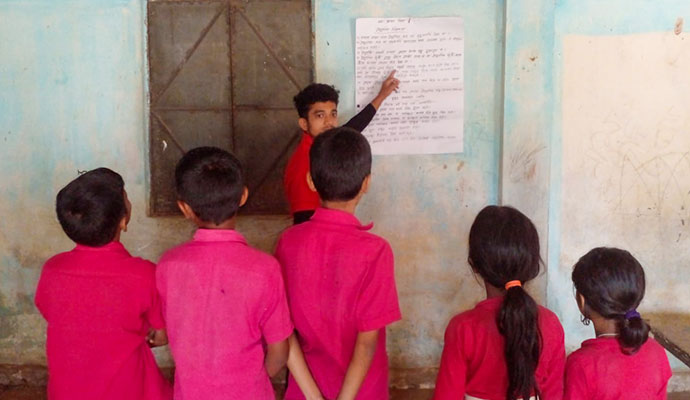 Instructor explaining electrical safety precautions to school students in a classroom